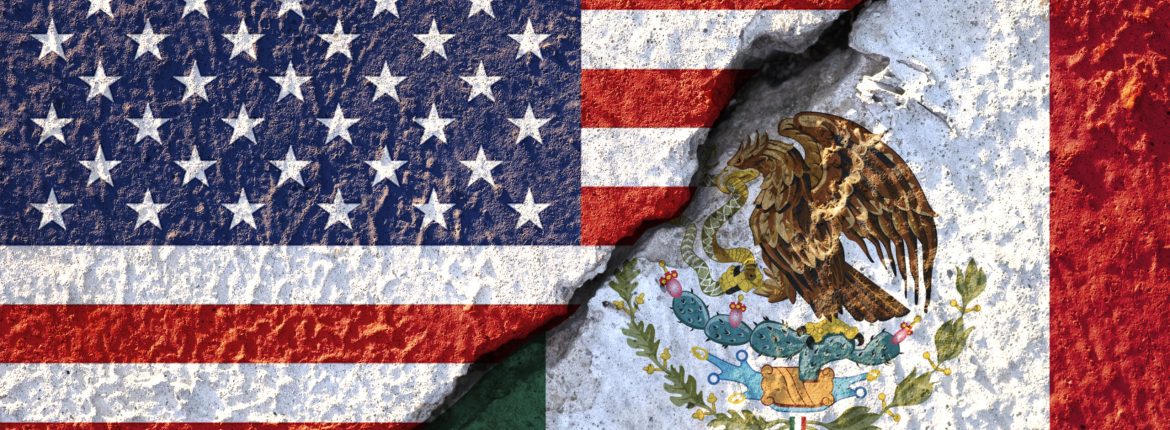 USA flag and Mexico flag on cracked wall damage.