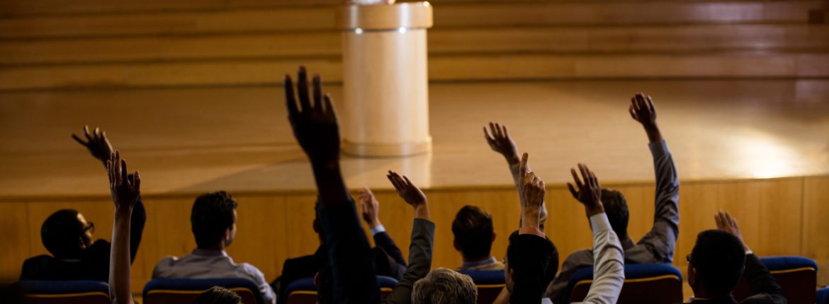Female business executive giving a speech at conference center