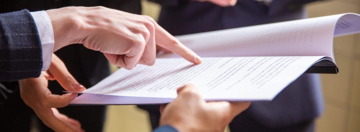 Cropped view of businesswomen reading document. Closeup shot of female finger pointing at page. Business concept